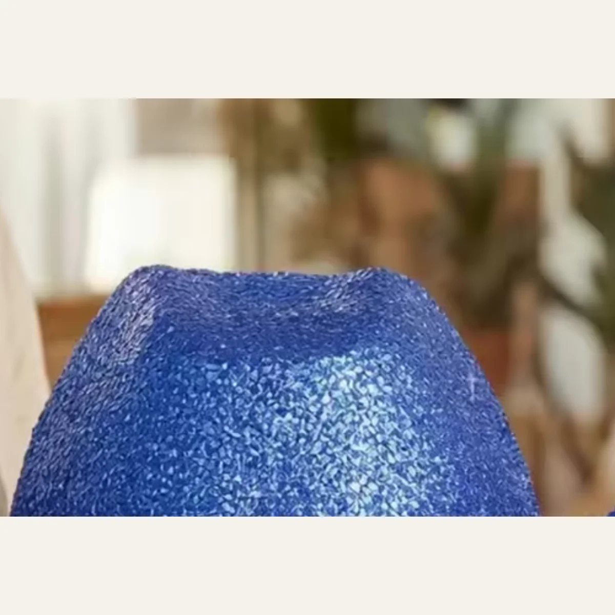 Close-up of blue glitter sequin texture on disco cowboy hat