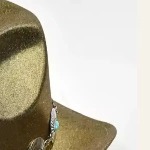 Close-up of champagne gold sequin texture and concho band on cowboy hat