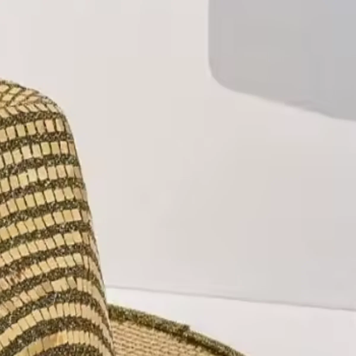Close-up of dense gold sequin texture on cowboy hat brim
