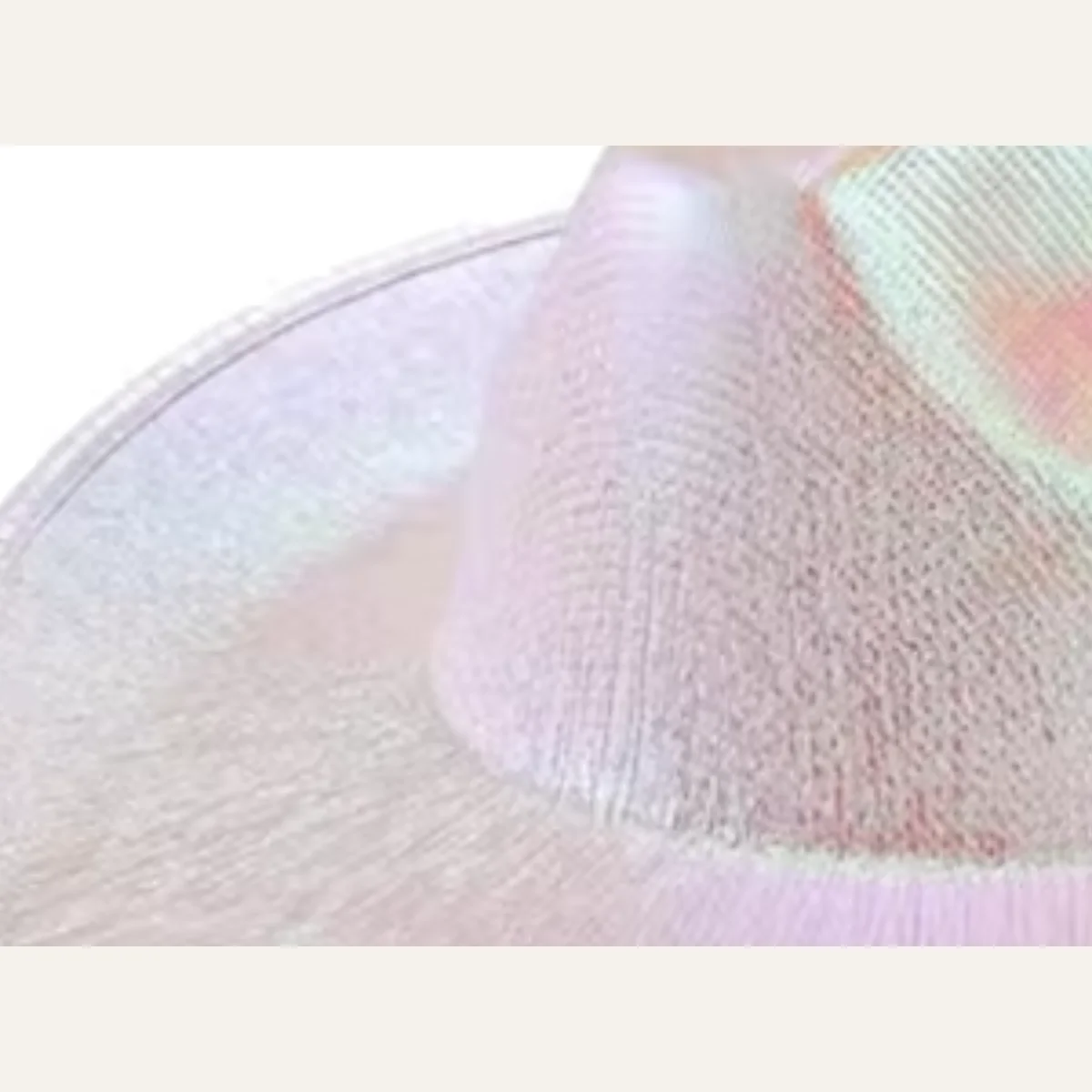 Close-up of woven pearlescent fabric texture on iridescent white disco cowboy hat