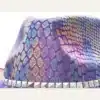 Close-up of iridescent purple snakeskin-pattern sequin texture on disco cowboy hat