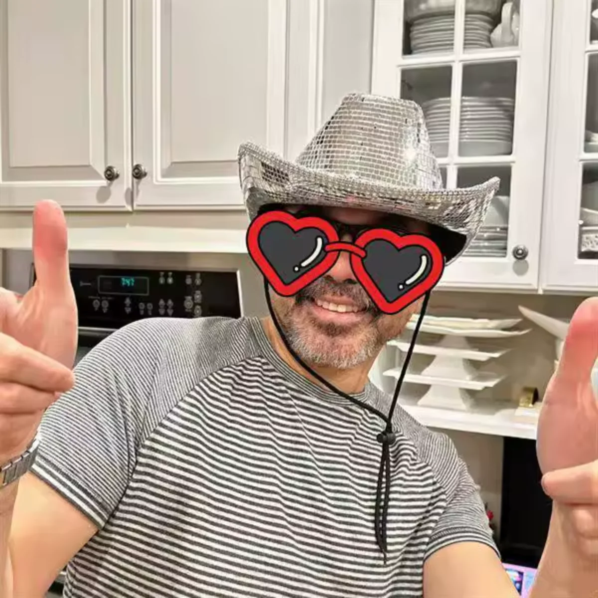 Customer wearing the Silver Mirror Disco Cowboy Hat at home, smiling