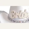 Closeup of pearl Bride lettering and glitter band on white bridal cowboy hat