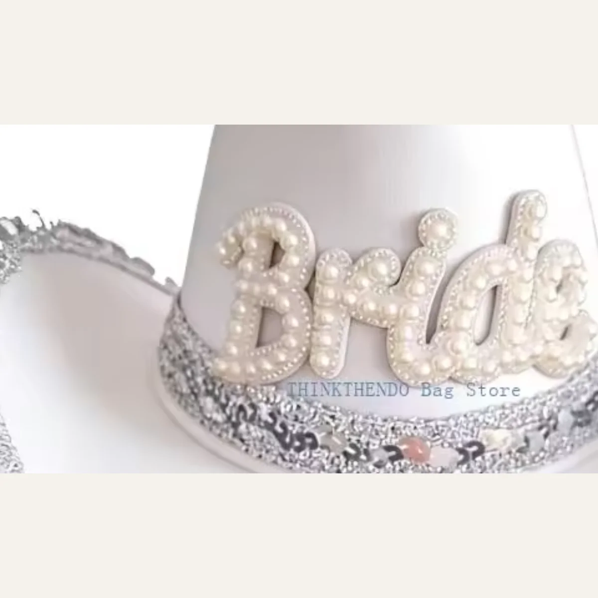 Closeup of pearl Bride lettering and glitter band on white bridal cowboy hat