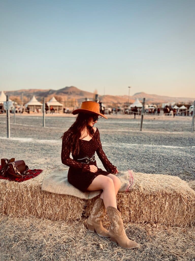 Woman wearing a sparkly sequin cowboy hat styled with a disco cowgirl festival outfit