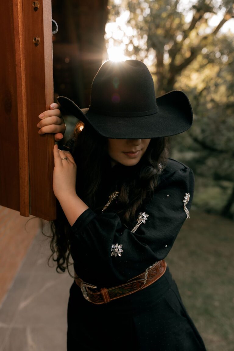 Woman in a western outfit and rhinestone cowboy hat styled as a disco cowgirl Halloween costume