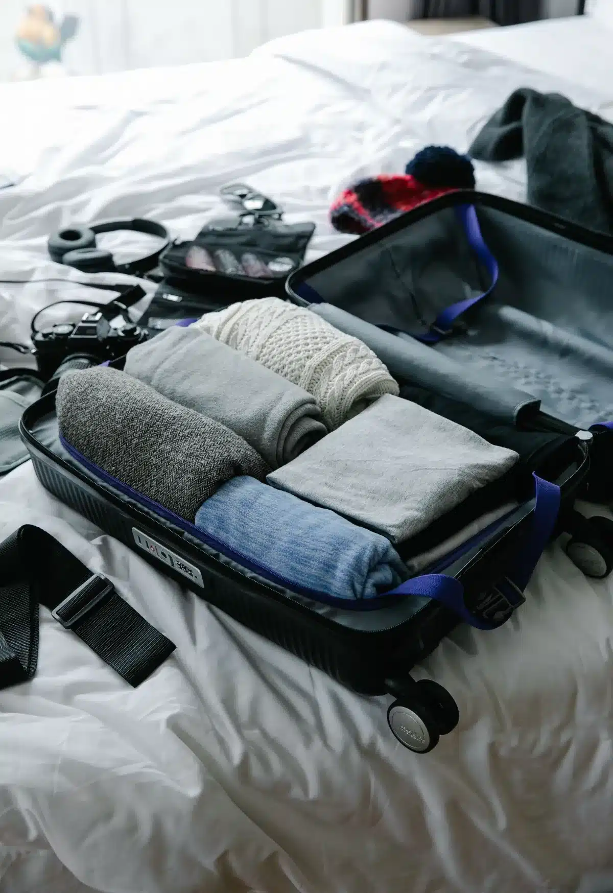 Open suitcase packed with neatly folded clothes ready for travel