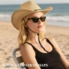 Woman wearing the Natural Straw Sun Cowboy Hat with sunglasses on a sunny beach